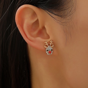Close-up of reindeer Christmas earring with gold plating and white sparkling crystals