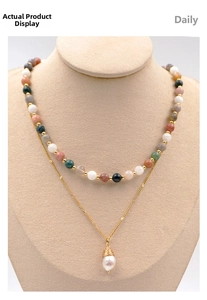 Detail of layered autumn necklace featuring multi-colored beads and a pearl pendant