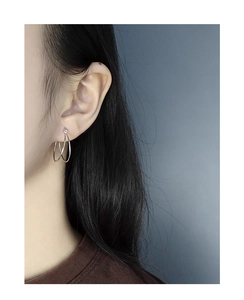 Close-up of minimalist S925 sterling silver double hoop earrings on a female model