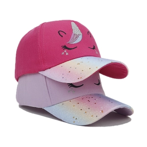 Close-up of kids unicorn baseball caps with glittery star visors and embroidered details
