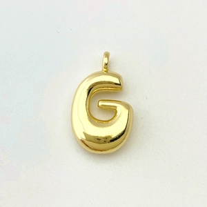 Detailed macro view of the gold-plated balloon letter G pendant with polished finish