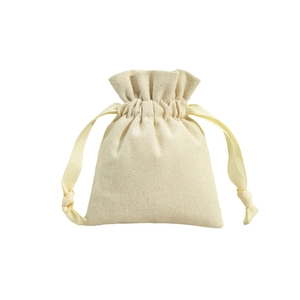 Beige cotton linen drawstring jewelry pouch with elegant ribbon closure on white background