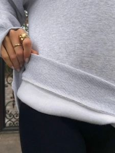 Close-up detail of grey sweatshirt showing the thick white fleece lining texture