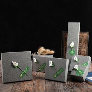 Elegant grey gift boxes in various sizes with Just for You labels and calla lily decor