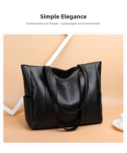 Detail view of large black leather tote bag featuring side pockets and smooth texture