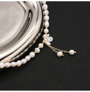 Detailed view of a natural freshwater pearl necklace with an elegant flower pendant