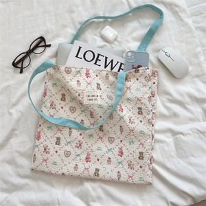 Detail of printed canvas tote bag interior showing spacious capacity for laptop and phone