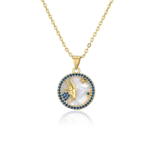 Detailed shot of gold plated Capricorn pendant with blue stones and shell inlay