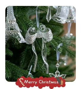 Close-up of sparkling transparent Eiffel Tower and bell ornaments on Christmas tree