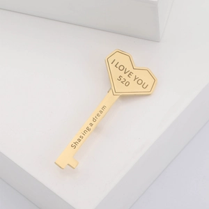 Macro shot of gold heart-shaped key brooch with I LOVE YOU 520 and dream engravings