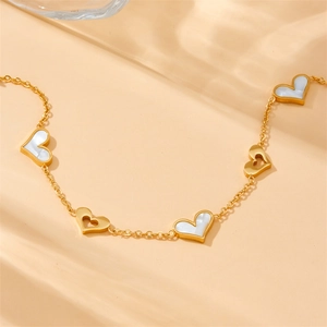 Elegant gold-plated stainless steel chain with hollow hearts and white shell inlays