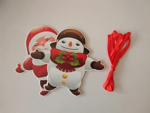 Close-up of Santa Claus and snowman paper flags with a red ribbon for Christmas decor