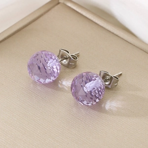Detailed close-up of faceted light purple crystal stud earrings with silver metal posts