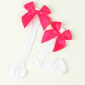 Close-up of white mesh knee high socks featuring elegant pink satin bows for girls