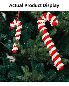 Detail of red and white spiral foam candy cane ornaments hanging on a green Christmas tree