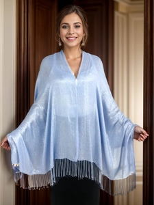 Close-up of sparkling blue evening shawl featuring elegant fringe tassel details