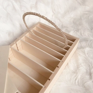 Detail view of wooden storage box with compartments for headbands and jewelry