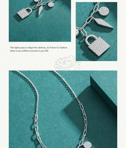 Close-up of S925 silver paperclip chain necklace with sparkling lock and key pendants