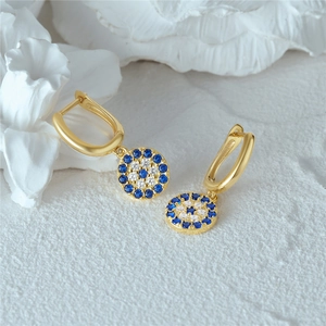 Detailaufnahme goldener Evil Eye Ohrringe mit blau-weißen Mikropavé-Kristallen