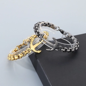 Men's titanium steel anchor bracelets in 18k gold and silver finish on a display