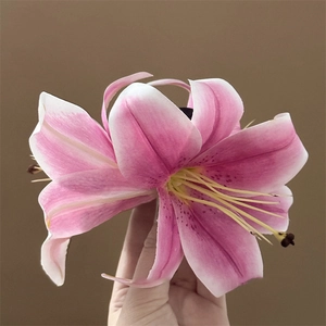 Detailed close-up of a realistic pink lily hair claw clip with intricate petal textures
