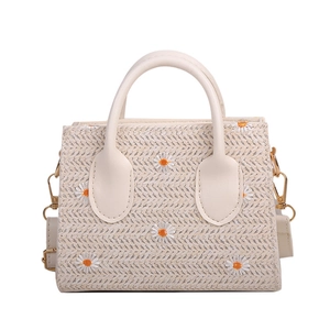 Chic cream woven crossbody handbag featuring white daisy embroidery and gold hardware