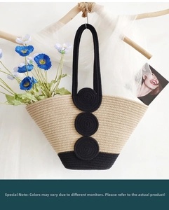 Detail of woven beige cotton rope tote with black round accents and slim handles