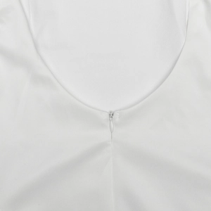 Detail of invisible back zipper and round neckline on a sleek white bodycon dress