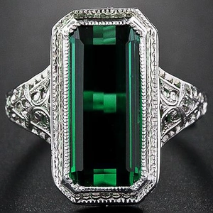 Vintage art deco emerald cut green gemstone ring with hollow silver floral engraving
