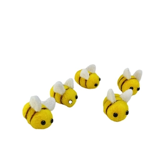 Set of five handmade wool felt bees with yellow bodies and white wings for DIY crafts