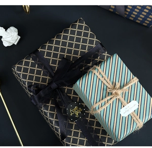 Close-up of premium blue grid and geometric patterns on gift wrapping paper with ribbons