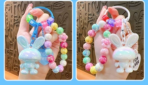 Close-up of cute acrylic bunny charms with iridescent beads and heart pendants