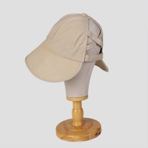Close-up of beige sun hat with breathable cotton linen texture and ponytail hole detail