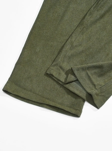 Close-up of olive green corduroy jogger hem featuring reinforced stitching and texture