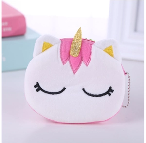 Detail of plush unicorn coin purse featuring soft white fur and golden sequined horn
