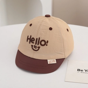Detailed close-up of quick-dry baseball cap with smile embroidery and short brim for baby