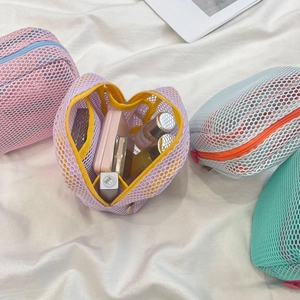 Detail view of purple mesh makeup bag showing interior storage for small cosmetics
