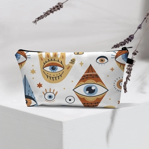 Detail of waterproof evil eye makeup bag featuring mystic patterns and black zipper