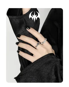 Detail of S925 silver irregular rings with blue zircon inlay on dark silk background