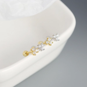 Detail of 925 sterling silver stud earrings set in gold and silver with clear cubic zirconia