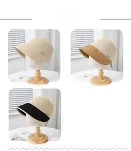 Detail of three-color straw equestrian sun hats in beige, khaki and black finishes