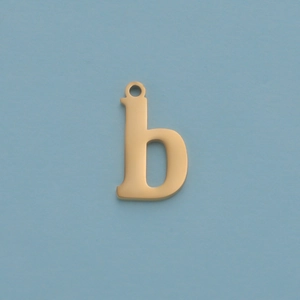 Macro shot of gold letter 'b' pendant with polished finish on blue background