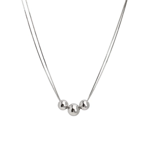 Sleek silver snake chain necklace featuring three polished minimalist metallic beads