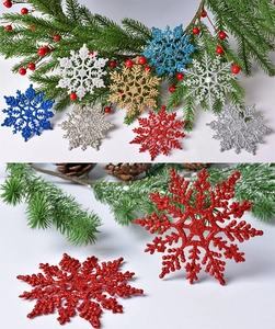 Macro shot of glittery Christmas snowflake ornaments in red, gold, and blue colors