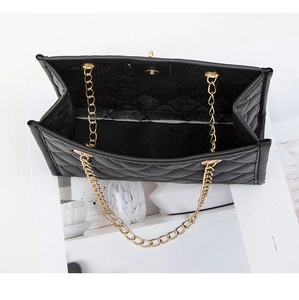 Overhead detail view showing the spacious interior and golden chain of the quilted bag