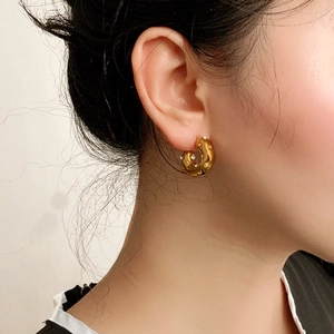18K gold plated stainless steel C-shape earrings with hammered texture on model