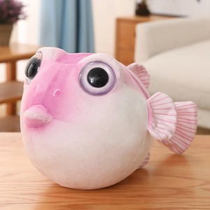 Gros plan détaillé d'un doudou poisson-globe rose sur un bureau en bois chaud