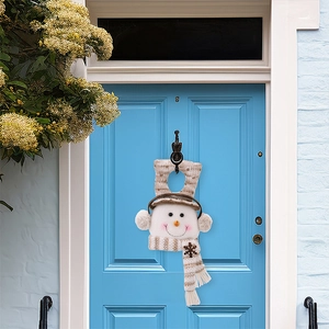 Close-up of a plush Christmas snowman door hanging on a blue background