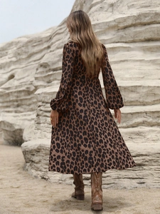 Detail of leopard print long sleeve midi dress with cinched waist and autumn style