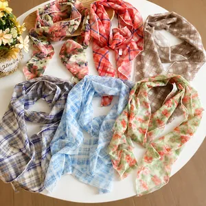 Pastoral plaid floral mesh scarf necklace collection displayed on a clean white round table